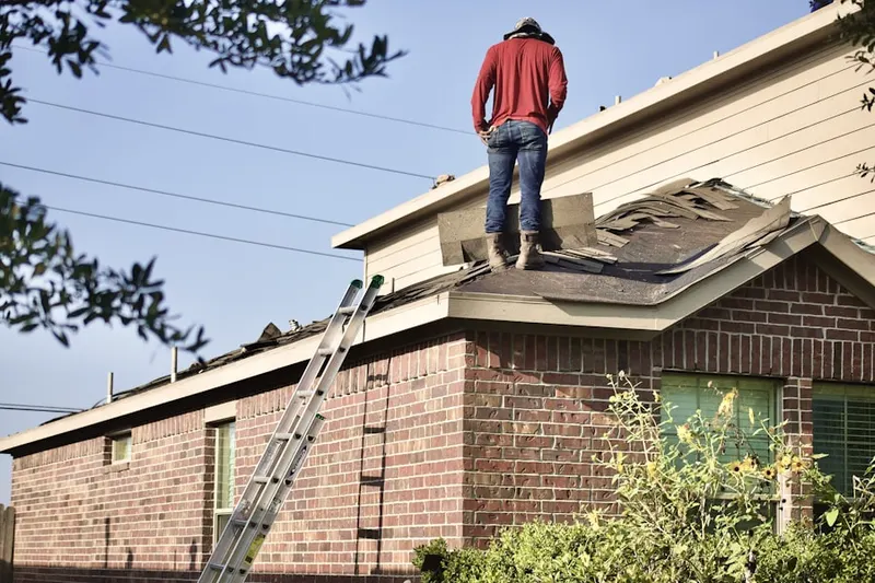 Professional roofer working on a residential roof in Downtown Paterson